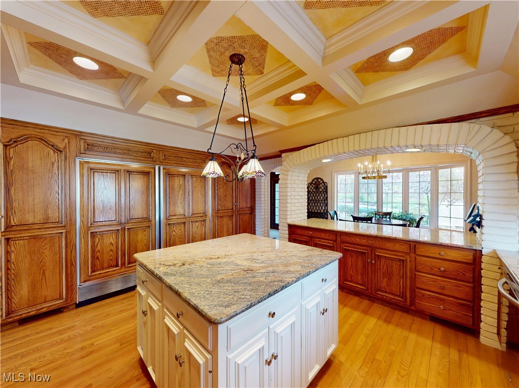 9870 Hobart Road Willoughby, OH 44094 - Photo 8 of 50 Kitchen featuring an inviting chandelier, a center island, light wood-style floors, and light stone counters