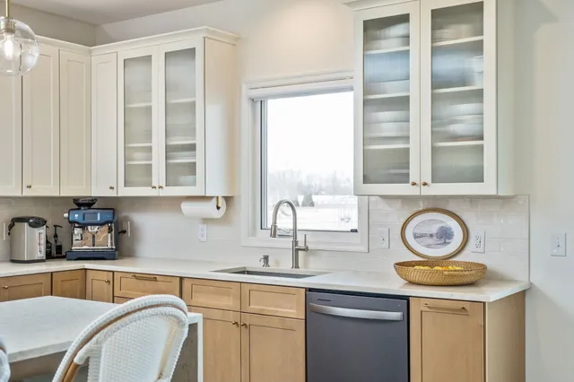 a kitchen with stainless steel appliances granite countertop a sink a stove and cabinets