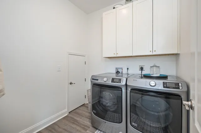 a utility room with sink dryer and washer