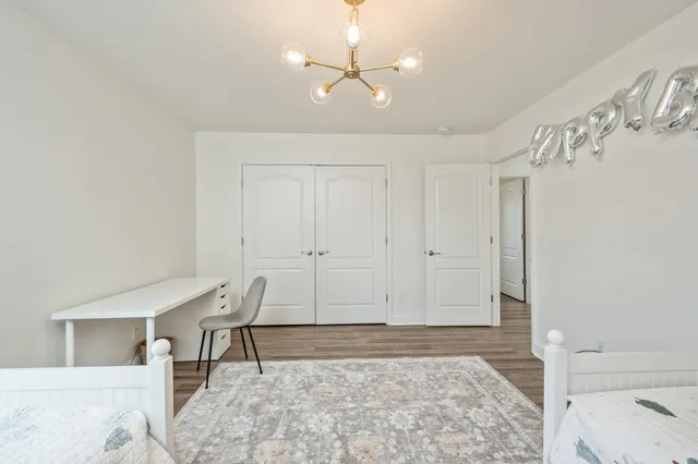 a view of a livingroom with furniture and chandelier fan