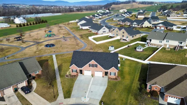 an aerial view of a house with a swimming pool yard and mountain view in back