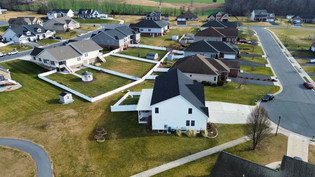 an aerial view of a house with swimming pool and outdoor seating