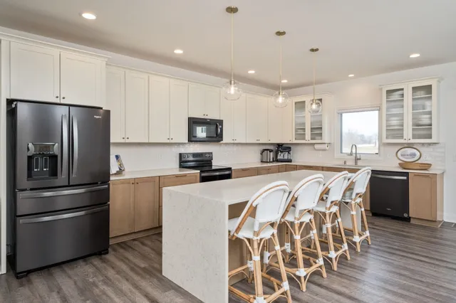 a kitchen with stainless steel appliances a refrigerator sink and microwave