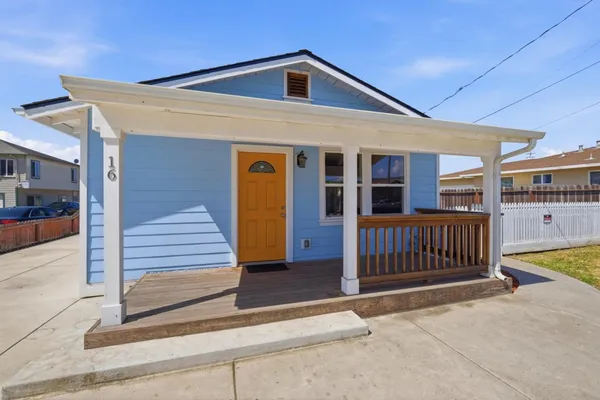 a view of a house with wooden fence