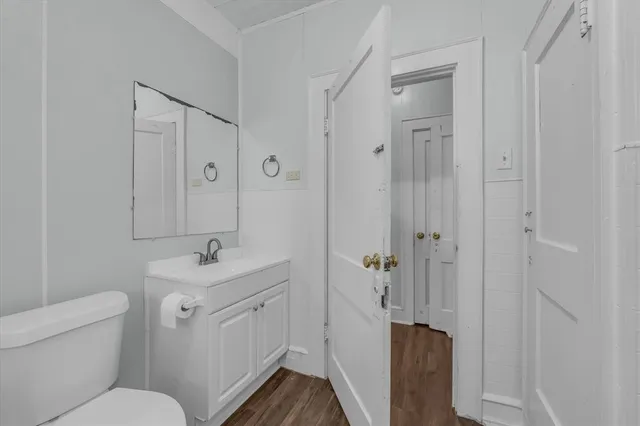 a bathroom with a toilet a sink and mirror