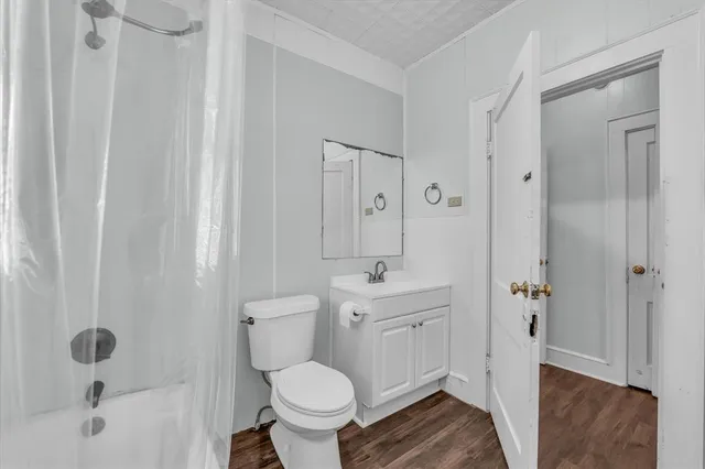a bathroom with a toilet a sink and shower