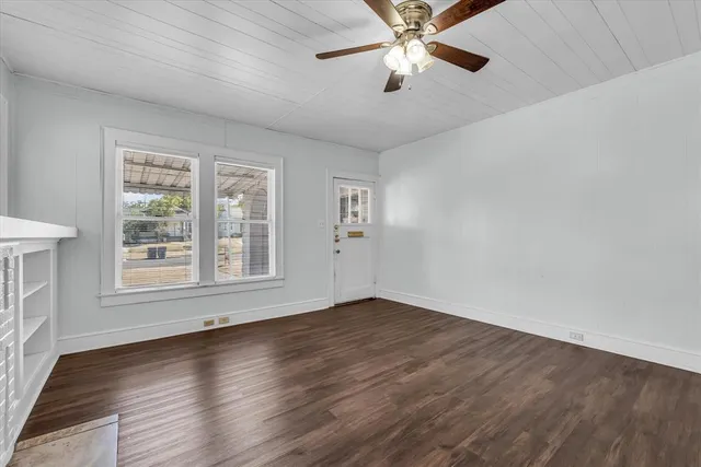 wooden floor in an empty room with a window