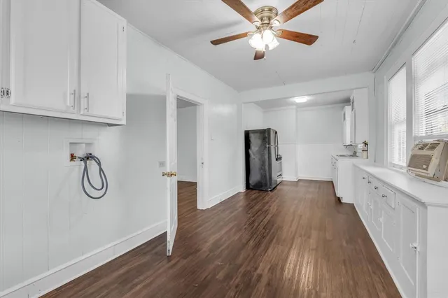 a view of a kitchen with a sink and wooden floor