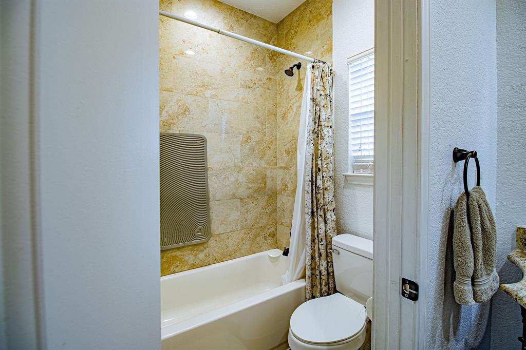 328 Meadow Lane Red Oak, TX 75154 - Photo 12 of 35 Full bathroom featuring shower / bath combo and a textured wall