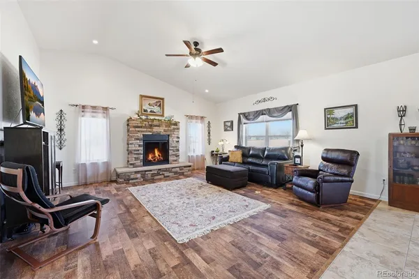 a living room with furniture flat screen tv and a fireplace