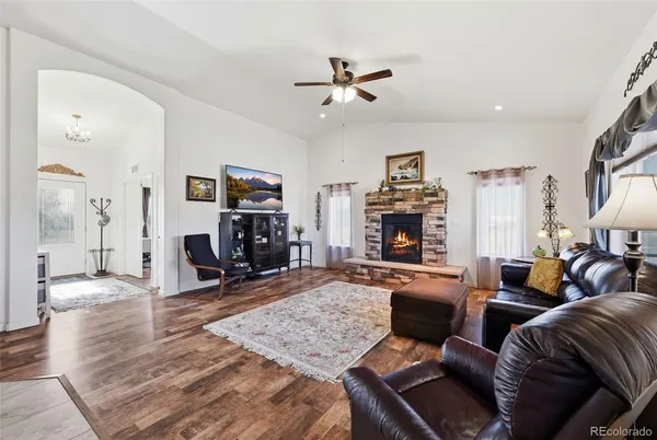 a living room with furniture and wooden floor