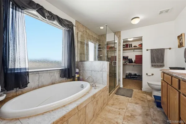 a bathroom with a granite countertop double vanity sink and mirror
