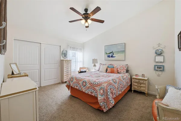 a bedroom with a bed and ceiling fan