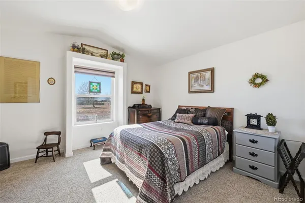 a room with a bed and a painting on the wall