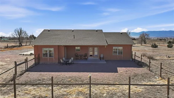 a front view of house with yard space and seating