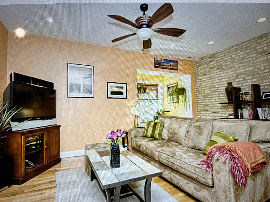 4446 North Beacon Street, Unit 3 Chicago, IL 60640 - Photo 2 of 13 a living room with furniture and a flat screen tv