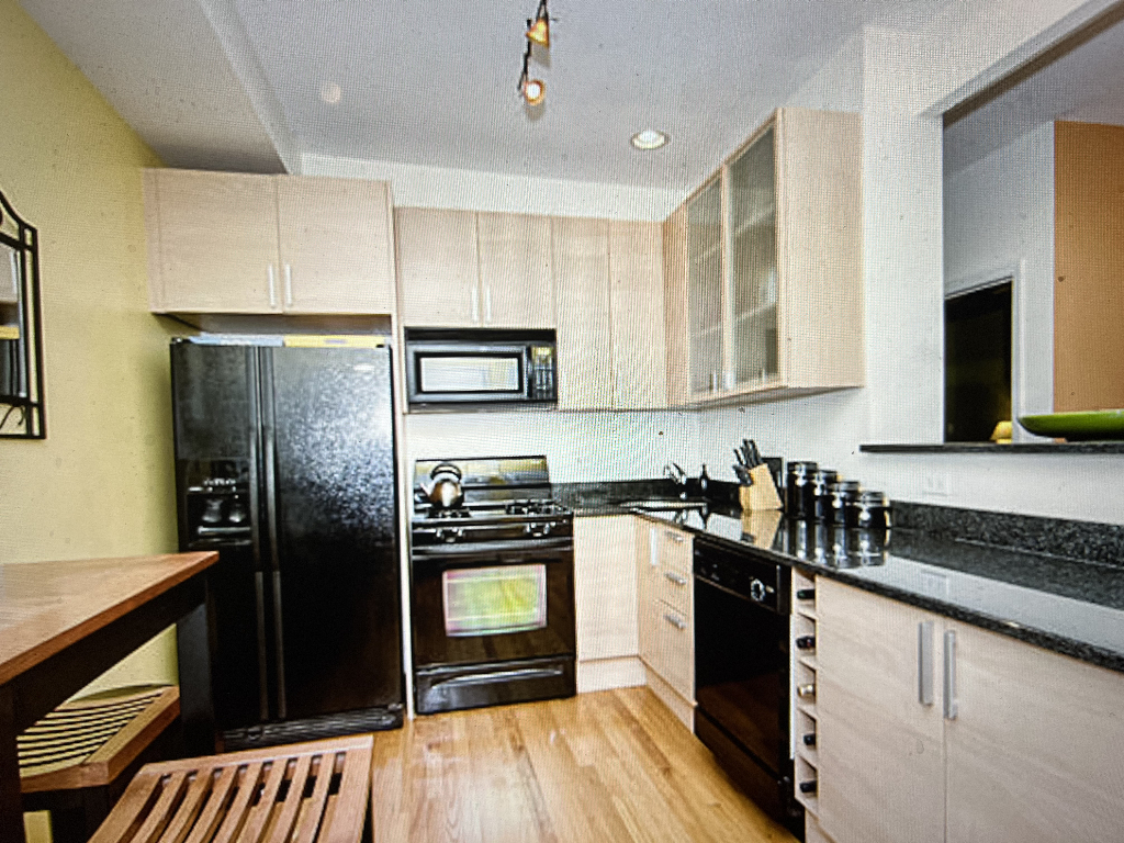 4446 North Beacon Street, Unit 3 Chicago, IL 60640 - Photo 5 of 13 a kitchen with a refrigerator stove and sink