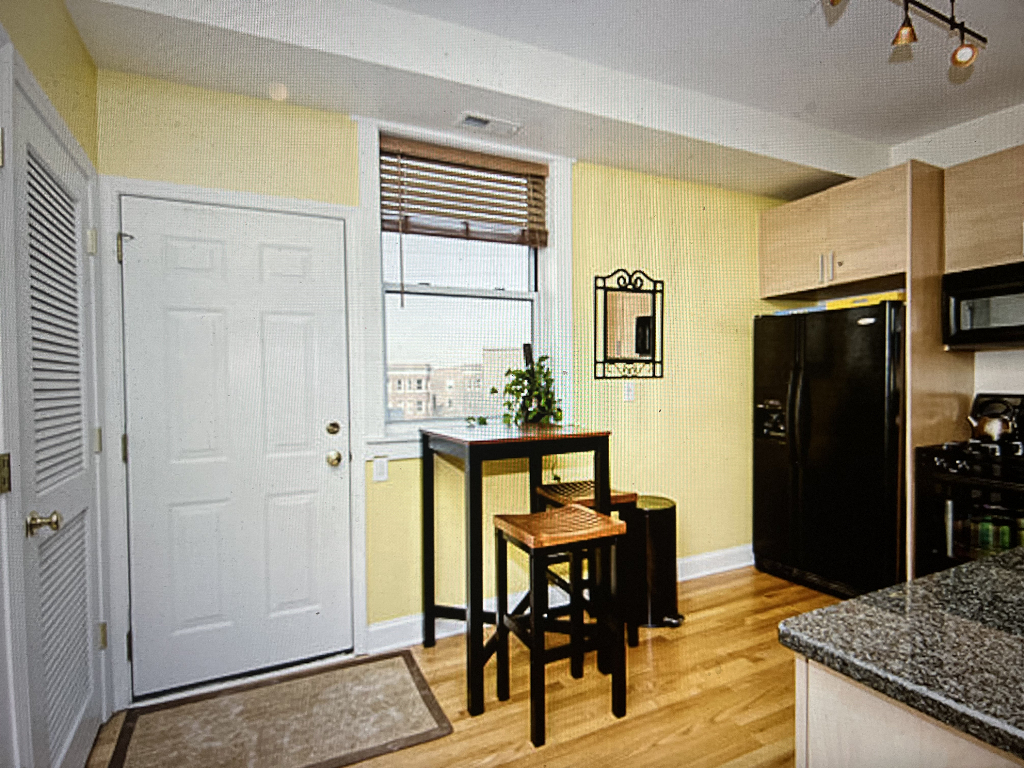 4446 North Beacon Street, Unit 3 Chicago, IL 60640 - Photo 6 of 13 a view of a dining room with furniture and a refrigerator