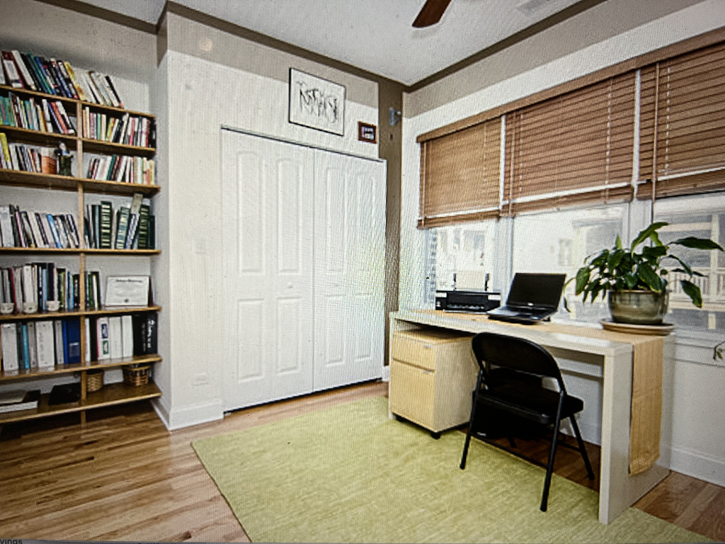 4446 North Beacon Street, Unit 3 Chicago, IL 60640 - Photo 8 of 13 a view of a workspace with furniture and a book shelf