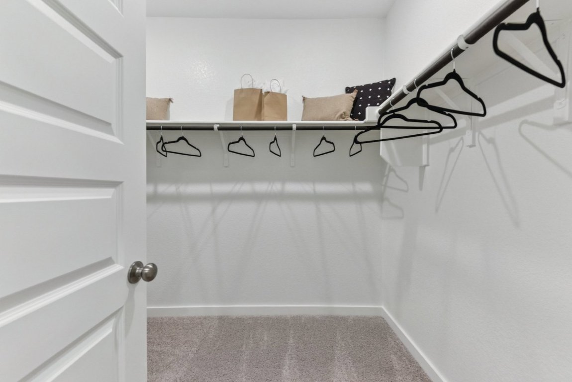 10610 Justify Lane Buda, TX 78610 - Photo 8 of 19 a view of a room with racks on the wall