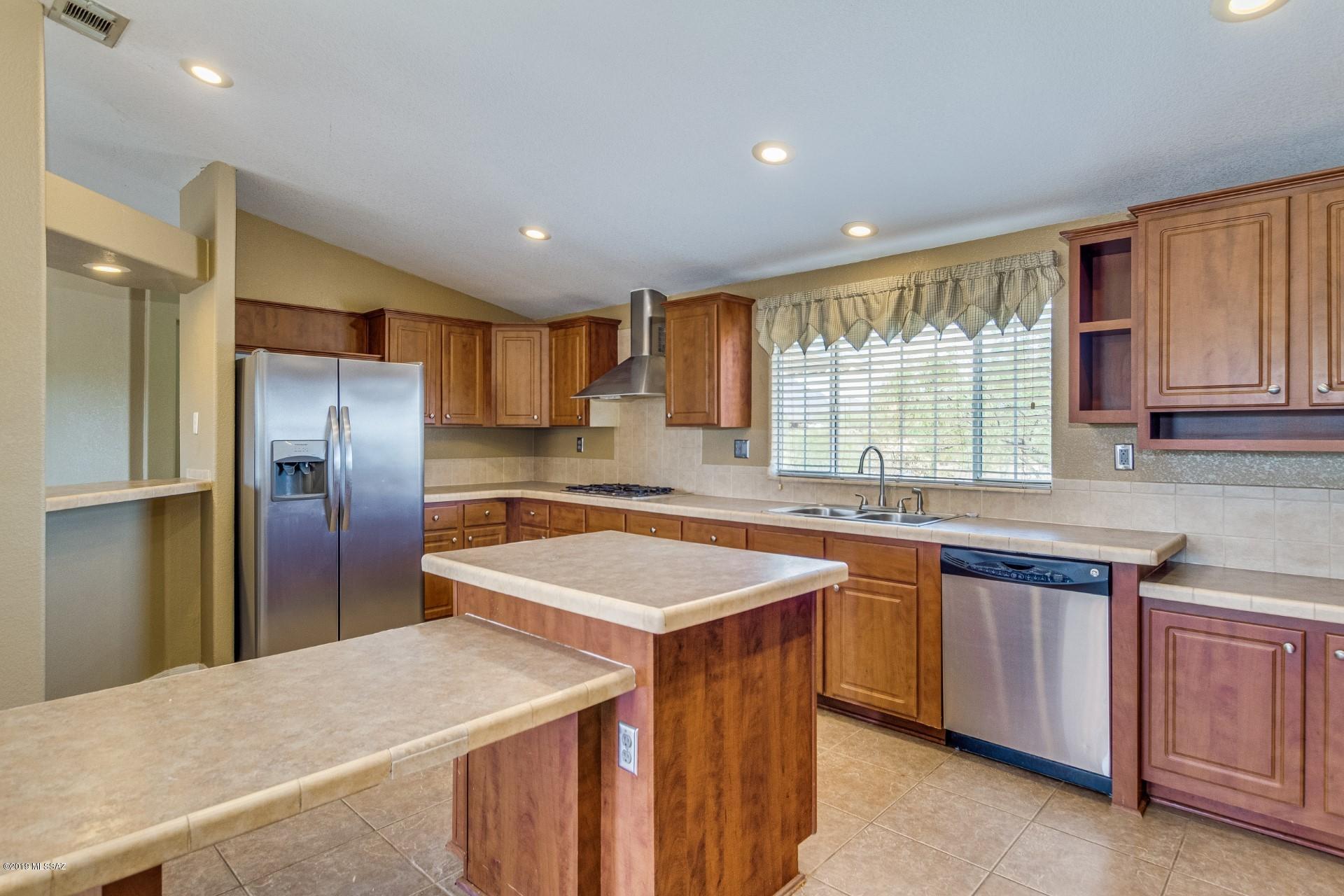 8945 West Bopp Road Tucson, AZ 85735 - Photo 5 of 21 a kitchen with stainless steel appliances granite countertop a sink a stove and a refrigerator