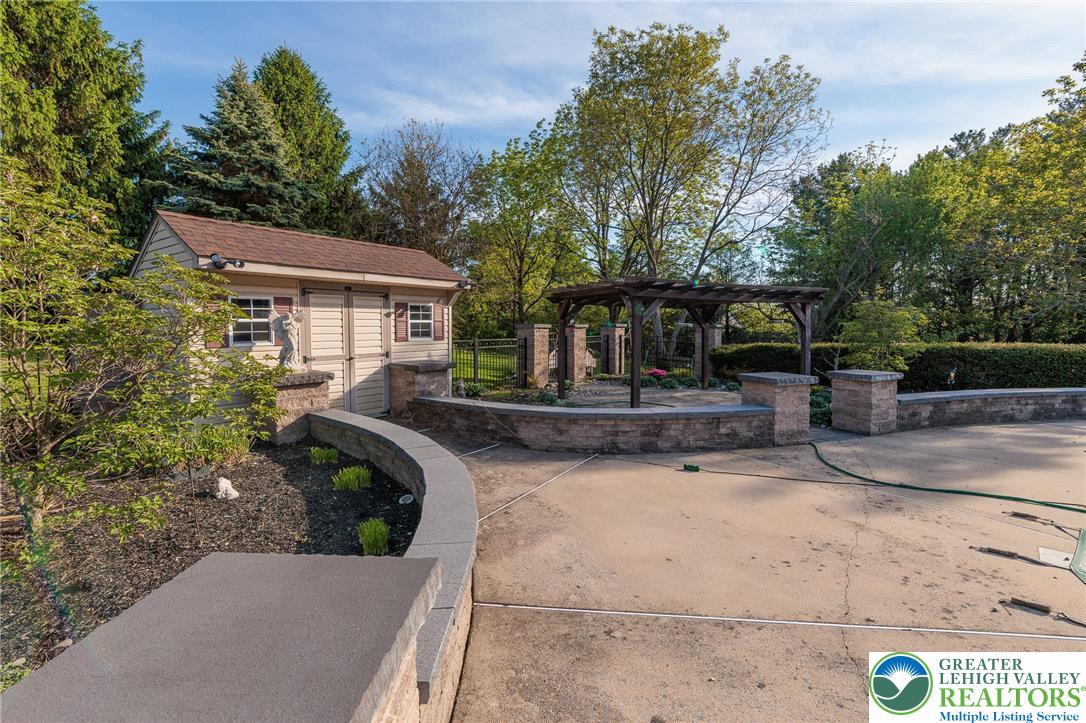 2170 Clearview Road Coplay, PA 18037 - Photo 66 of 75 An inviting backyard retreat features a pergola and a charming shed, offering both shade and storage.