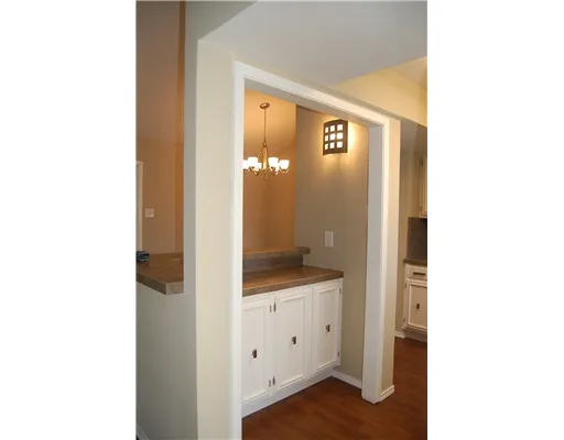 a en suite bathroom with a granite countertop sink and a mirror
