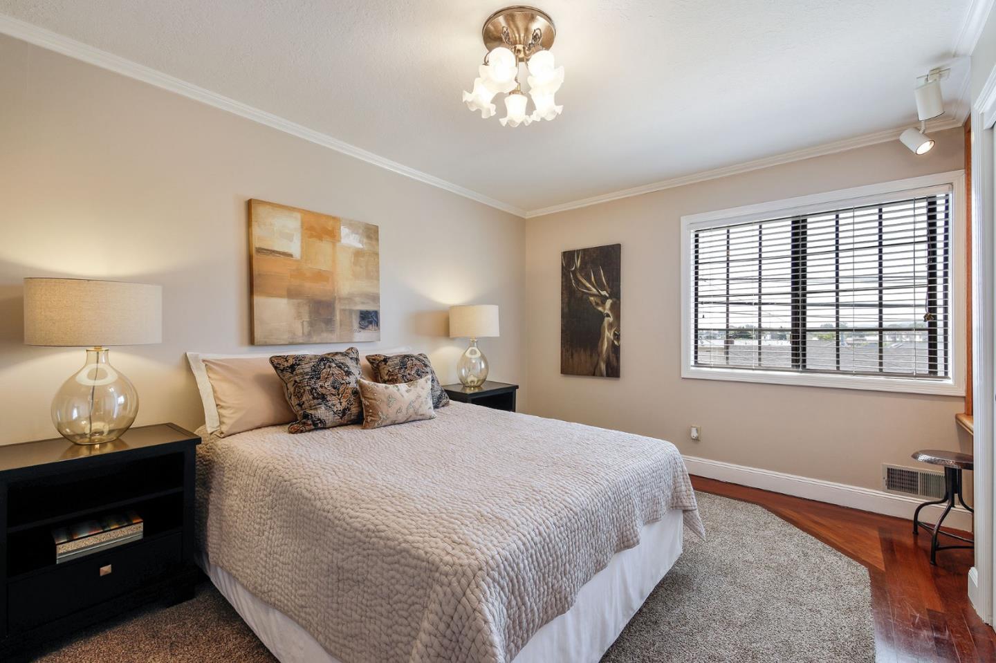 212 Helen Drive Millbrae, CA 94030 - Photo 12 of 24 a bedroom with a bed and a chandelier
