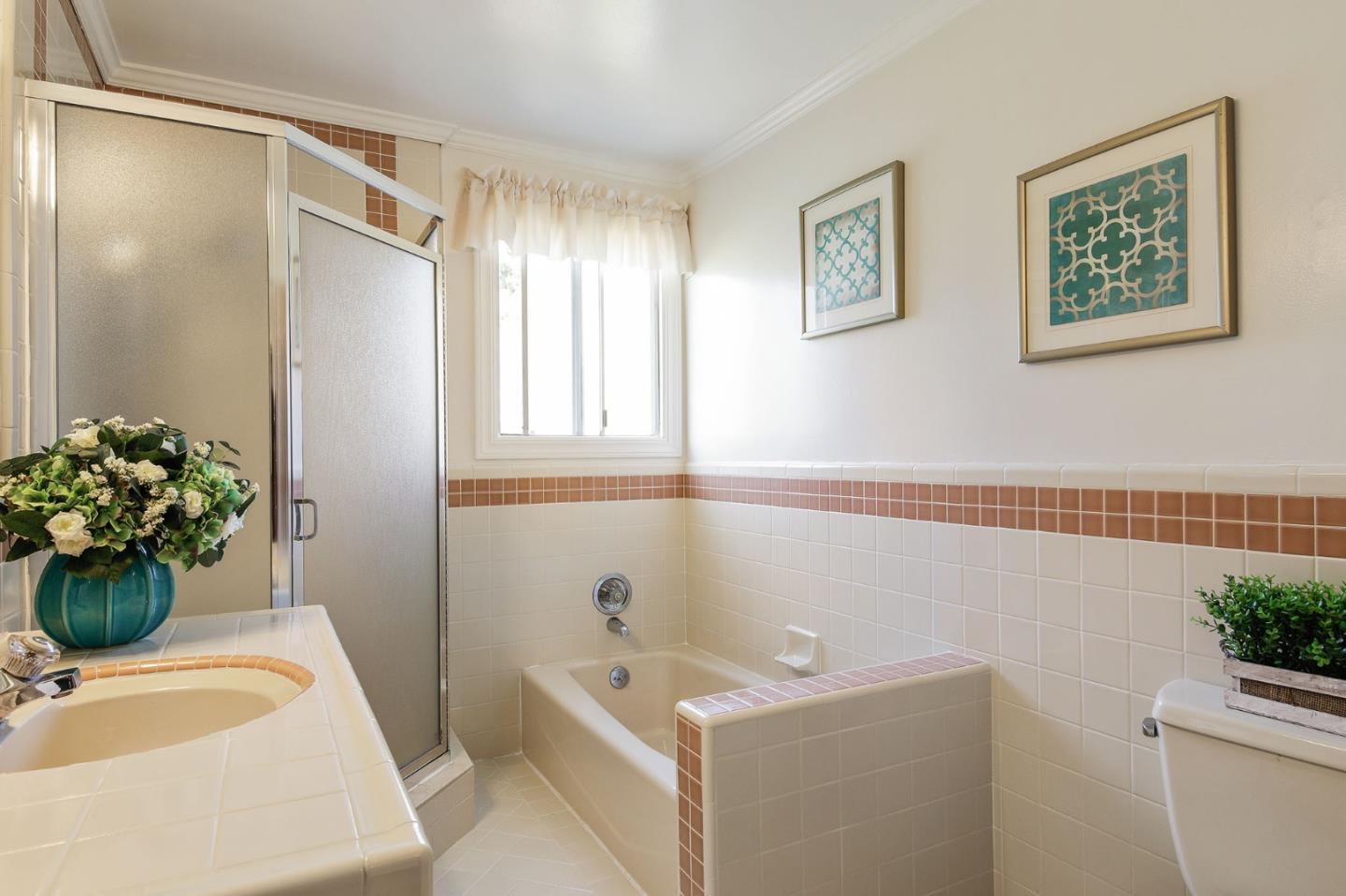 212 Helen Drive Millbrae, CA 94030 - Photo 10 of 24 a bathroom with a tub sink and mirror