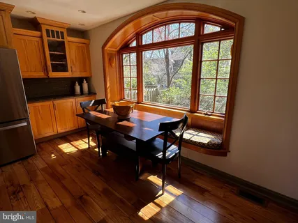 a dining room with furniture and wooden floor