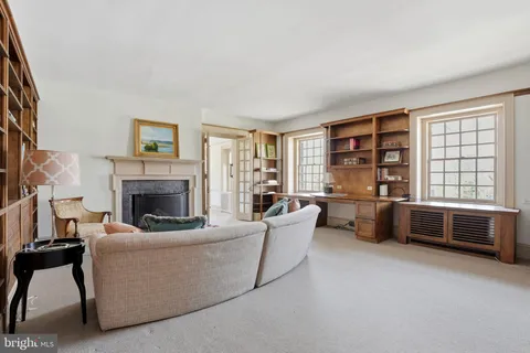 a spacious bedroom with a bed and a fireplace