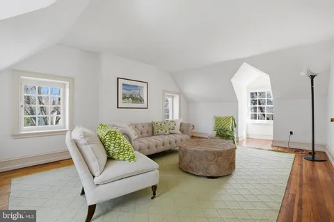 a bedroom with two beds and a desk