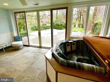 a picture of a bathroom with a shower and a mirror