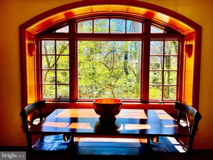 a view of a dining room with furniture and window