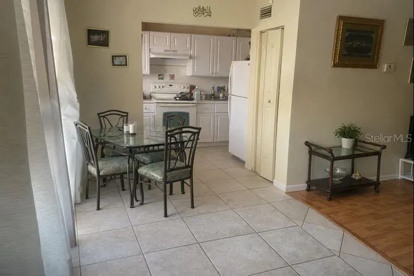 a dining room with furniture and a kitchen view