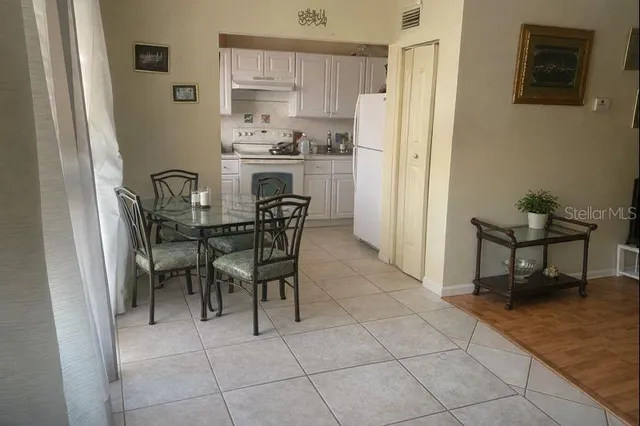 a dining room with furniture and a kitchen view