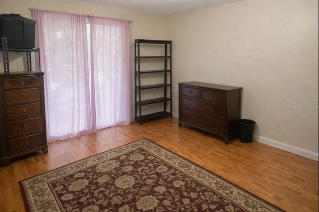 a bedroom with a bed and a television