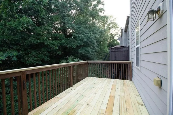 a balcony with wooden floor and fence