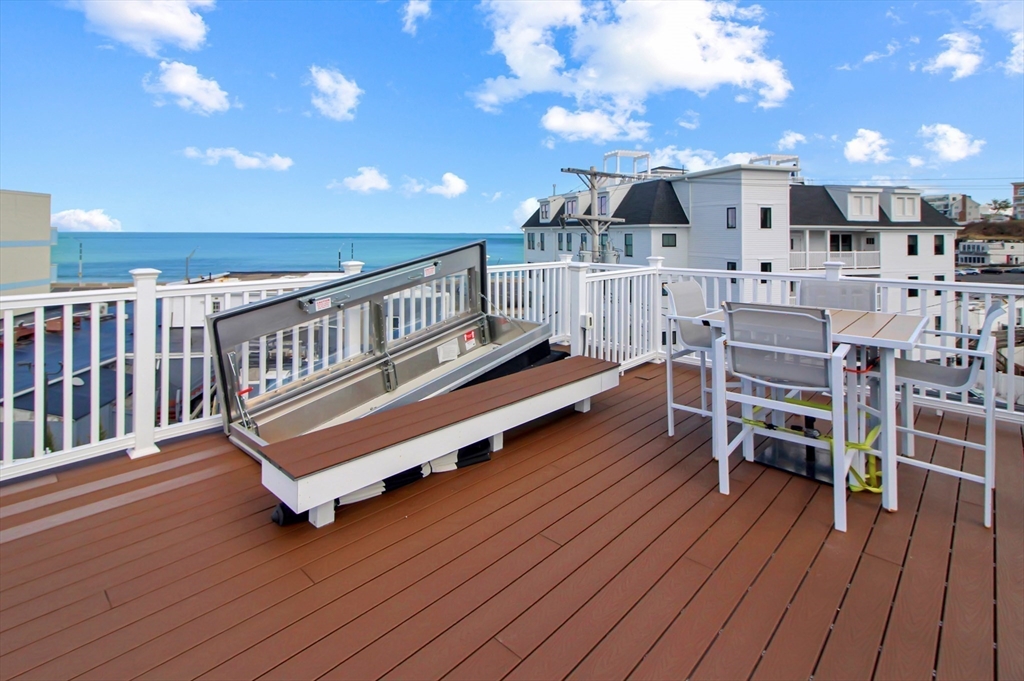 10 Berkley Road, Unit A Hull, MA 02045 - Photo 20 of 25 a roof deck with table and chairs