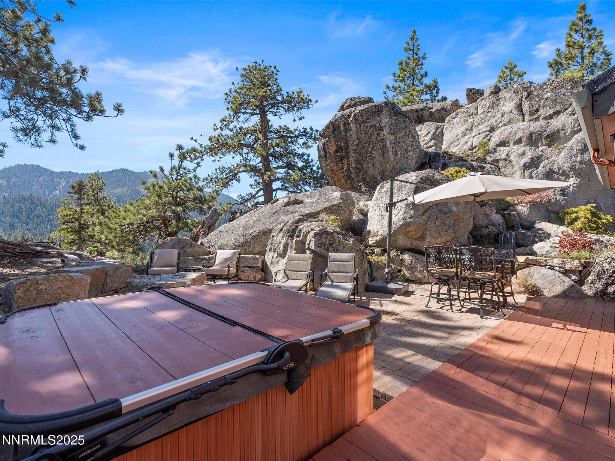 689 Tina Court Stateline, NV 89449 - Photo 63 of 102 a view of a patio with table and chairs with wooden fence