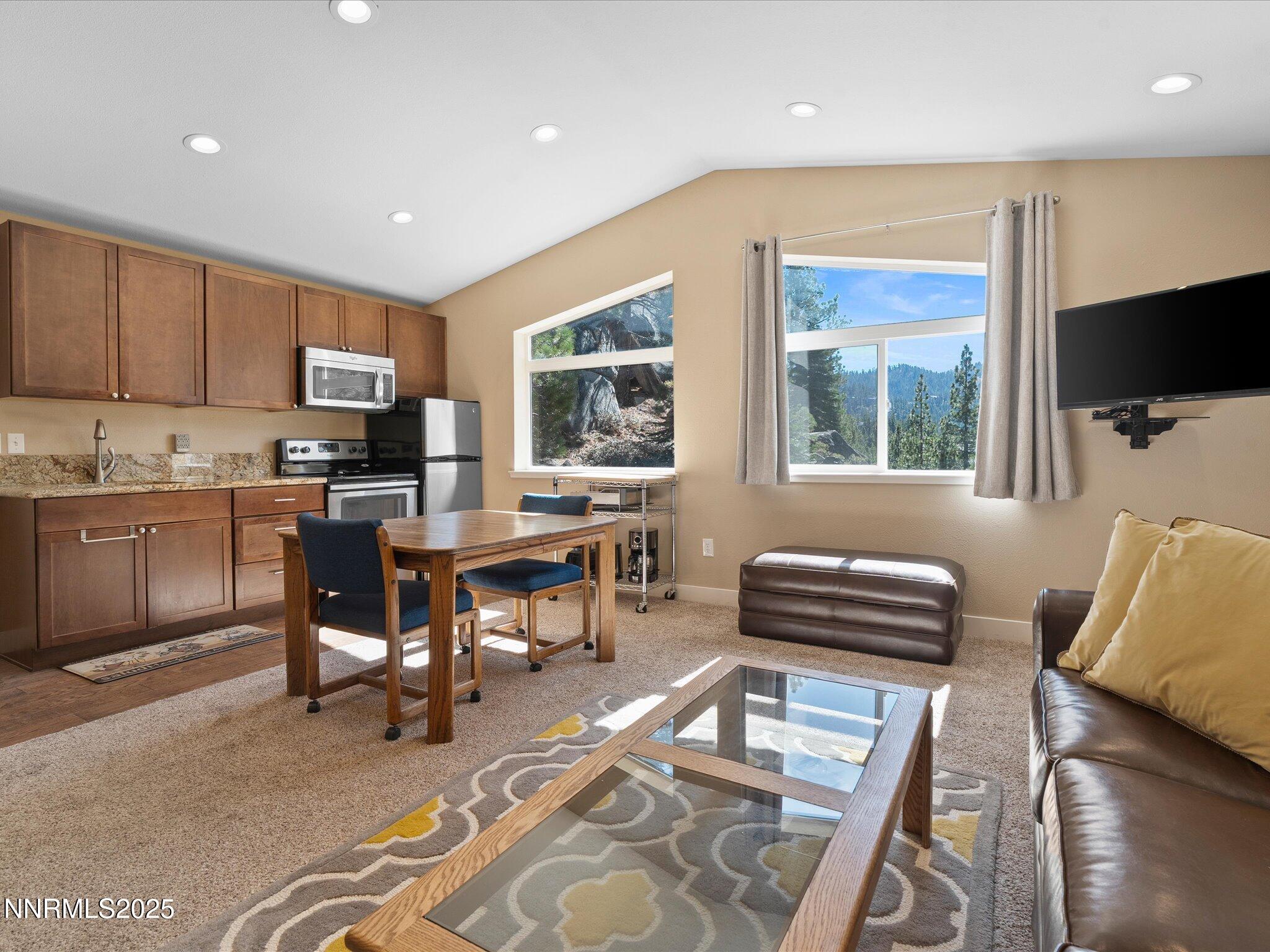 689 Tina Court Stateline, NV 89449 - Photo 79 of 102 a living room with furniture a flat screen tv and kitchen view