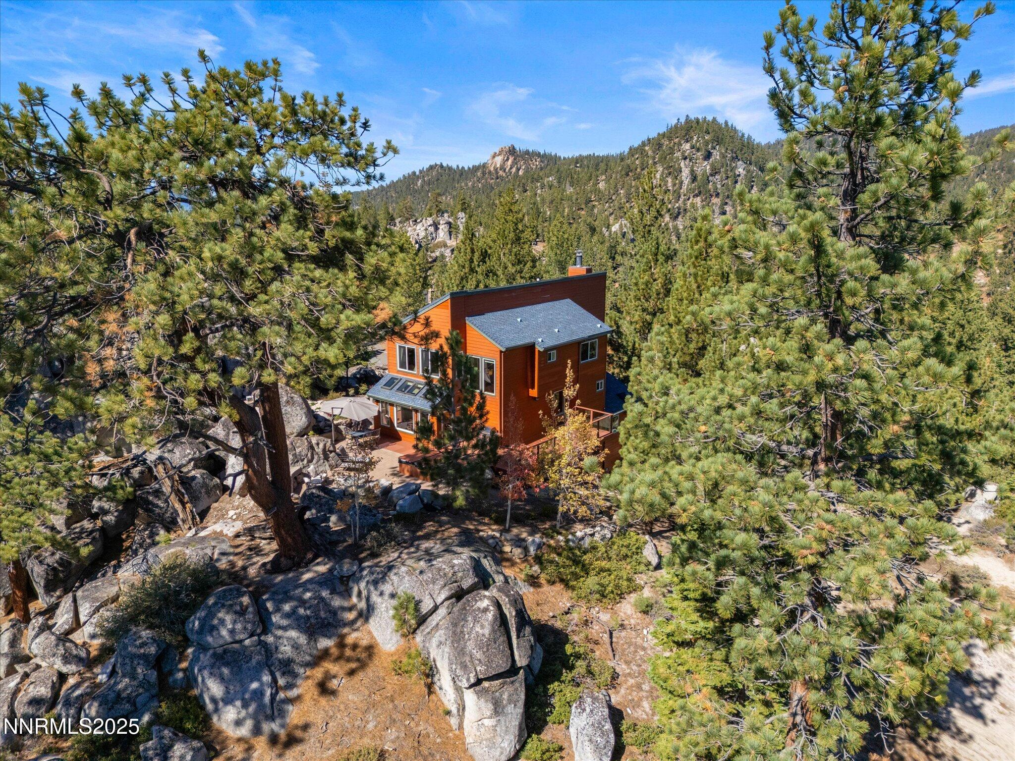 689 Tina Court Stateline, NV 89449 - Photo 90 of 102 a view of a house with a mountain and a forest