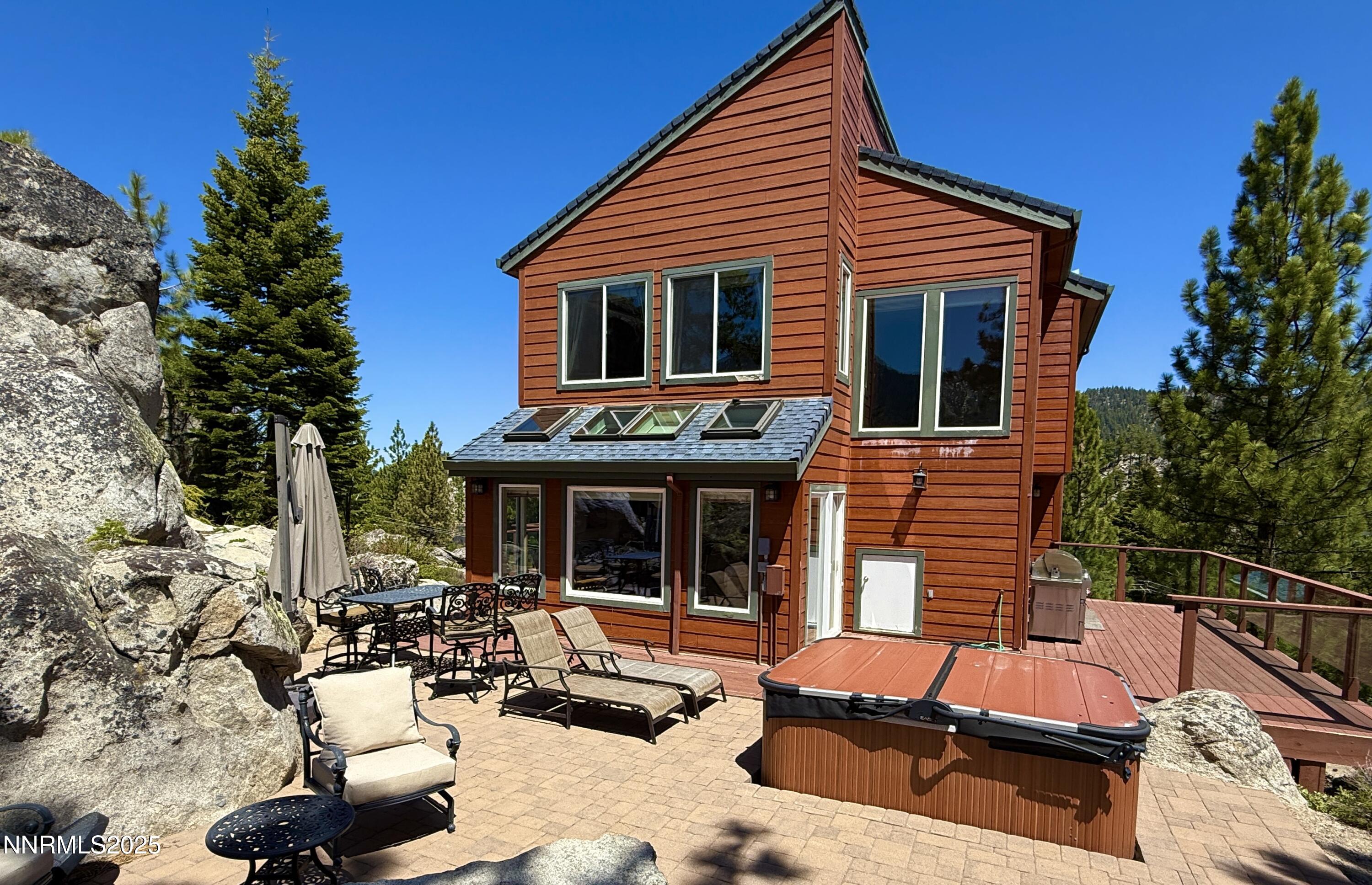 689 Tina Court Stateline, NV 89449 - Photo 9 of 102 a view of backyard with seating space and trees in the background