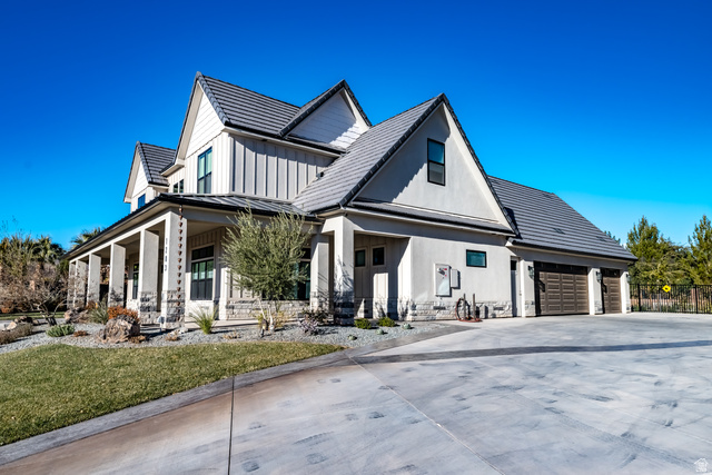 1283 North Gallen Road Santa Clara, UT 84765 - Photo 63 of 103 Modern farmhouse featuring a large porch, concrete driveway, a standing seam roof, a garage, and board and batten siding