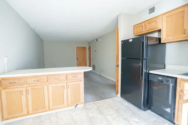 a kitchen with stainless steel appliances granite countertop a refrigerator and a stove