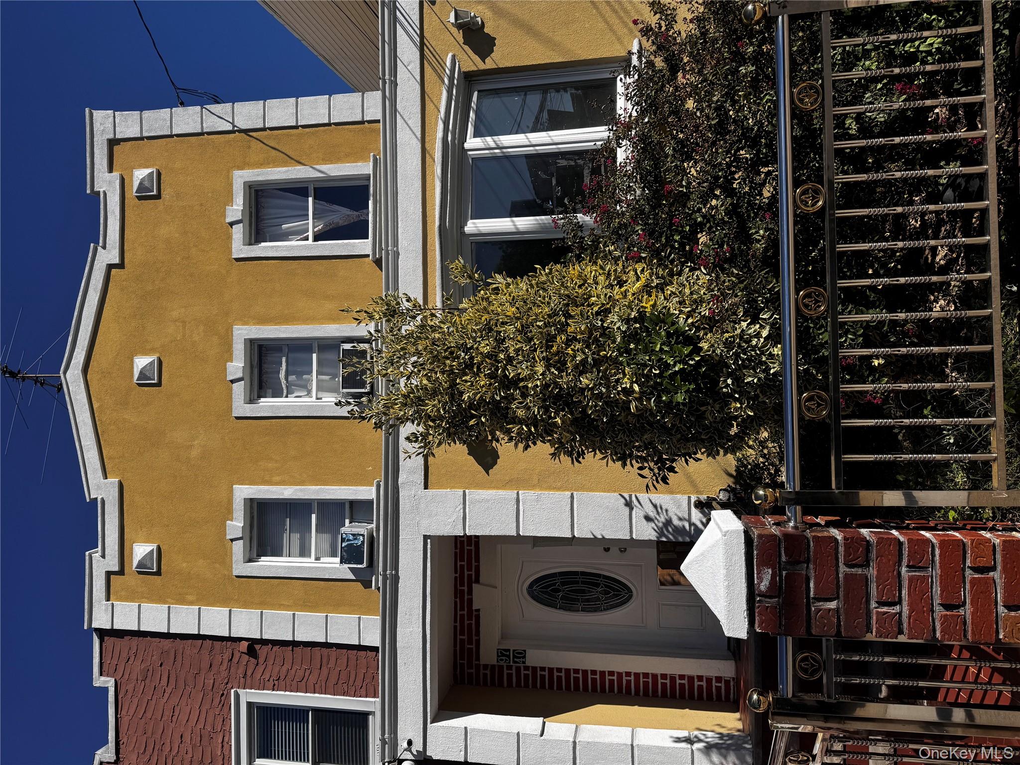 a front view of a house with a garden