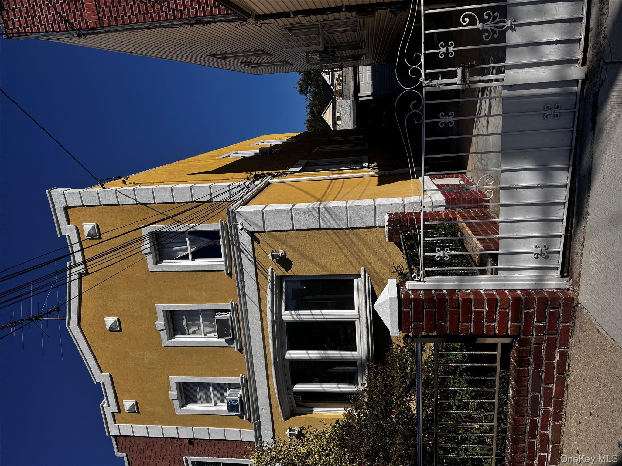 97-40 Corona Avenue Queens, NY 11368 - Photo 2 of 7 a front view of a house with glass windows