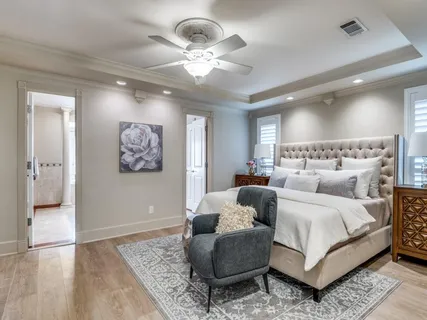 a bedroom with a large bed and a chandelier