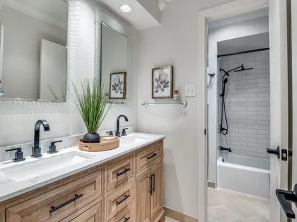 a bathroom with a tub sink and mirror