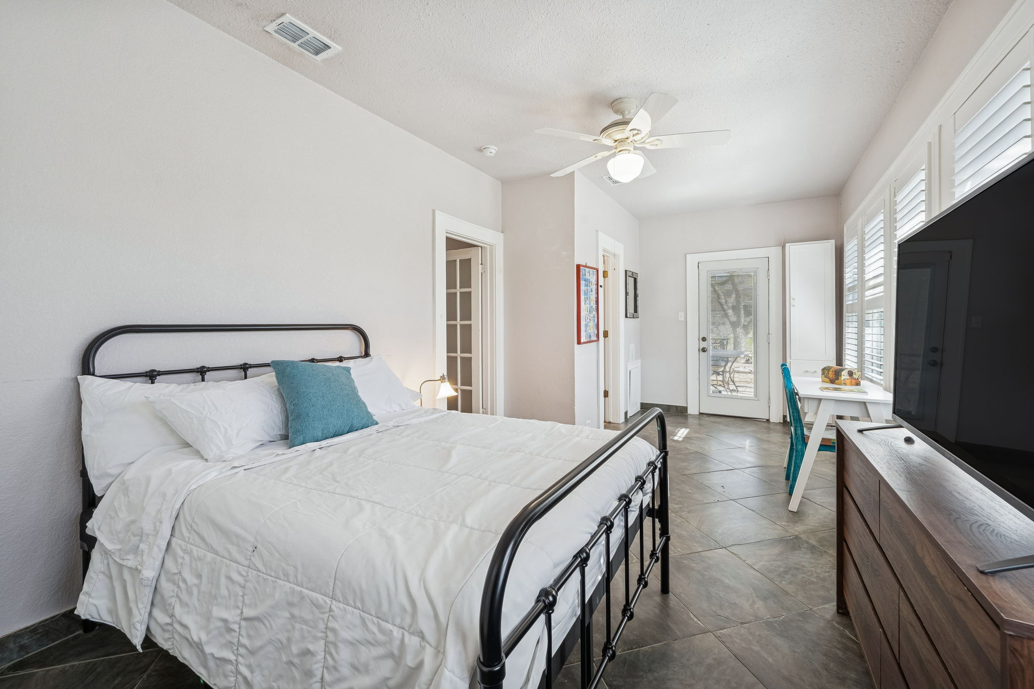 3101 Wheeler Street Austin, TX 78705 - Photo 13 of 20 a bedroom with a bed and a flat tv screen on dresser